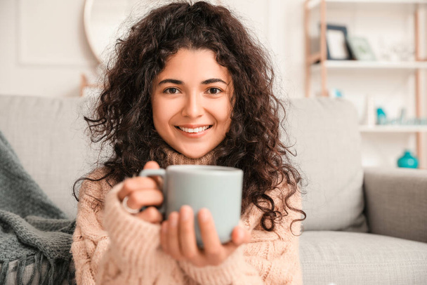 Beautiful young woman drinking hot tea at home - Photo, image