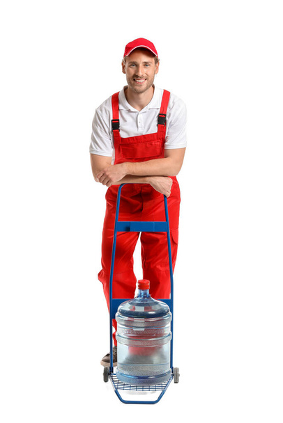 Delivery man with bottle of water on white background - Photo, Image
