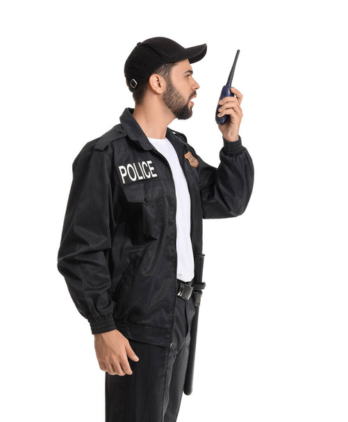 Handsome policeman with two-way radio on white background - Photo, Image
