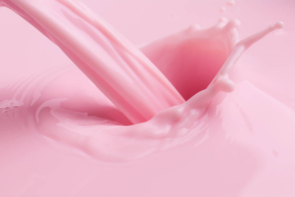Pouring of fresh pink milk, closeup - Foto, imagen