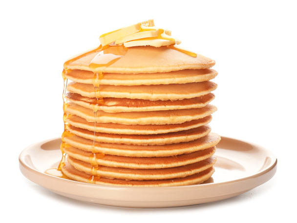 Lekkere pannenkoeken met honing en boter op witte achtergrond - Foto, afbeelding