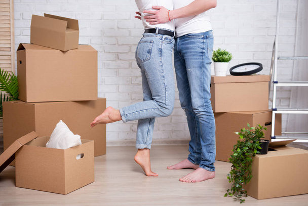 moving day - young couple embracing in their new house or flat - Photo, Image