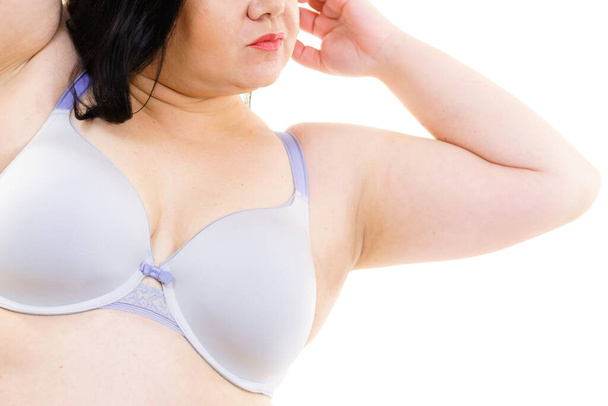 Plus size fat mature woman wearing comfortable bra, on white. Female breast in lingerie. Bosom, brafitting and underwear concept. - Foto, immagini