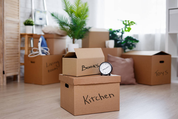 moving day concept - cardboard boxes with belongings prepared for moving into new house - Photo, Image