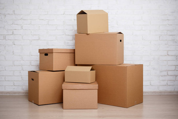 cardboard boxes over white brick wall background - Photo, Image