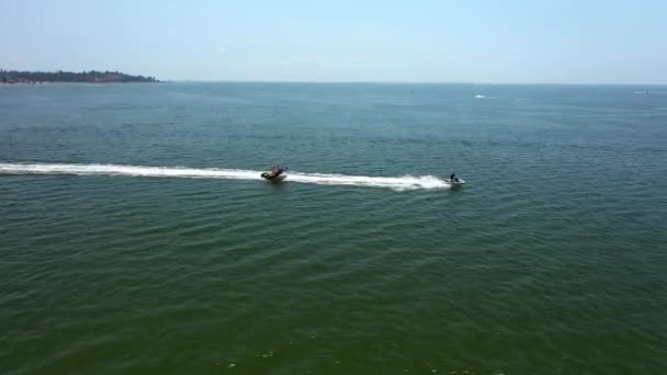 Vuelo Drone Aerial drone siguiendo Banana barco lleno de gente divirtiéndose en el mar
 - Metraje, vídeo