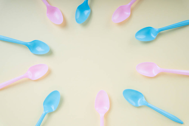 Colourful pastel utensil spoon and fork over bright yellow background. - Foto, afbeelding