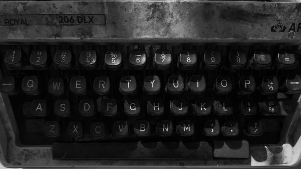 Una vieja máquina de escribir en el suelo. Tecnología de máquinas retro
.   - Foto, imagen