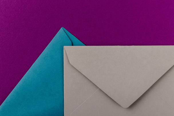 Colorful envelopes on a purple background. Mail envelopes on the table. - Fotó, kép