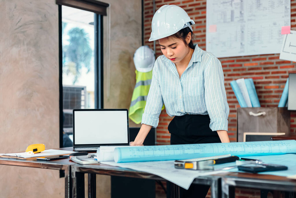 Engineer woman read drawing blue print on table workplace at room site construction. Engineer architect plan concept. - Photo, Image