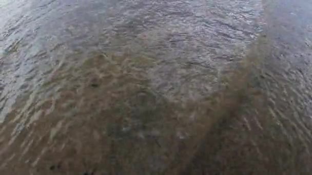  Waves runs on the sandy shore of the sea. Close-up. High quality 4k footag - Felvétel, videó