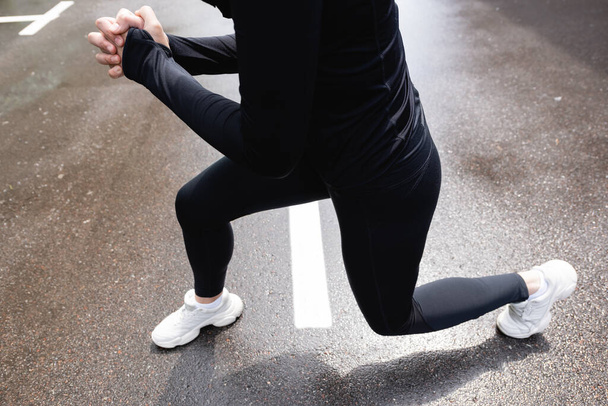 cropped view of woman with clenched hands exercising outside  - Foto, Imagem