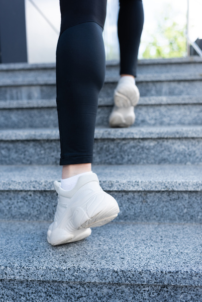 cropped view of sportswoman exercising in stairs outside - Fotoğraf, Görsel