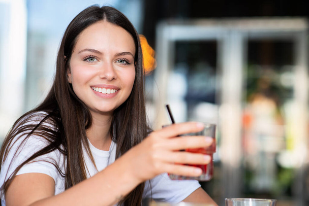 Woman drinking a cocktail outdoor - Photo, image