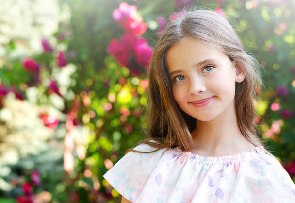 Portrait of adorable smiling little girl child in summer day. Happy preteen in the park outdoors  - Φωτογραφία, εικόνα