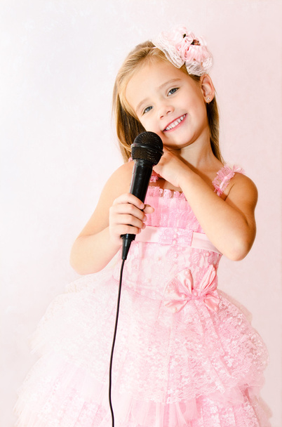 Beautiful little girl with microphone in princess dress - Foto, Imagen