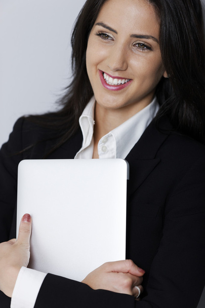 Woman holding her laptop - Фото, изображение