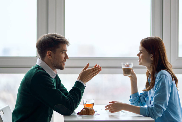Šťastní mladí lidé v kavárně a šálek čaje páru zamilovaných - Fotografie, Obrázek