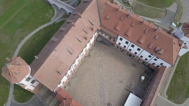 Mir Castle is one of the most famous historical cultural sites in Belarus. The five-tower building resembles a medieval fortress. Popular and visited object by tourists, above top view in slow motion. - Photo, Image