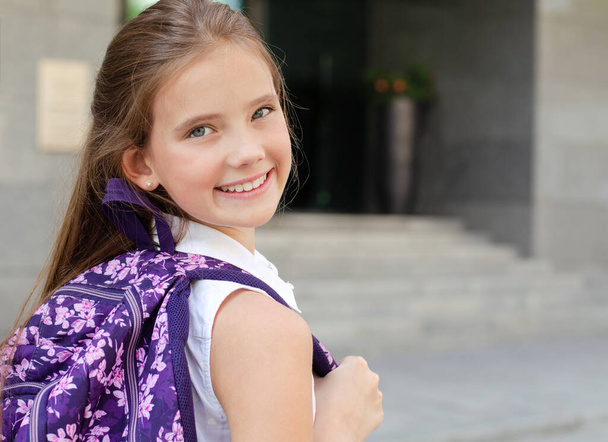 Back to school. Education concept. Cute smiling schoolgirl on the way to the school. Happy little girl child with backpack - Foto, afbeelding