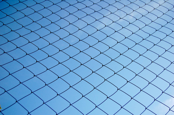 Metallic net with blue sky background - Photo, Image