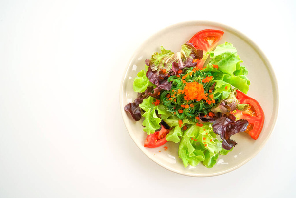 vegetable salad with Japanese seaweed and shrimp eggs isolated on white background - Photo, image