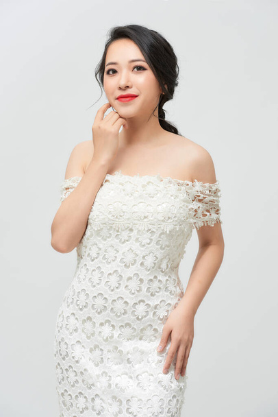 Young beautiful bride with a beautiful poses standing on white background. - Photo, Image