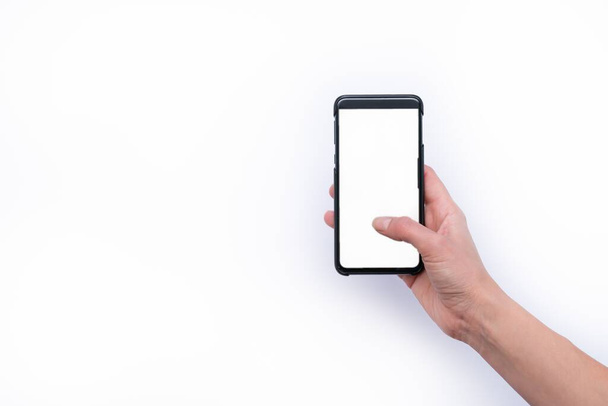 A closeup shot of a female hand holding a smartphone on white background - Foto, afbeelding