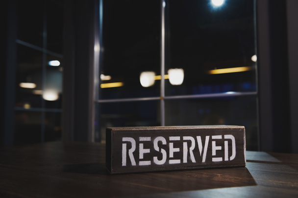 Vintage metal reserved table sign. Table reserve in restaurant. All tables are reserved. Dark bar. Copy space. - Valokuva, kuva