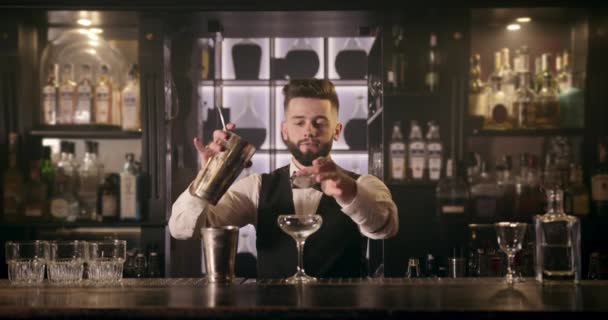 O barman está derramando o álcool da coqueteleira através de um coquetel no copo. 4k
 - Filmagem, Vídeo
