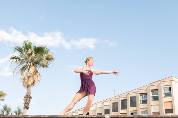 young blonde classic dancer dancing free in the city, dance and freedom concept, copy space for text - 写真・画像