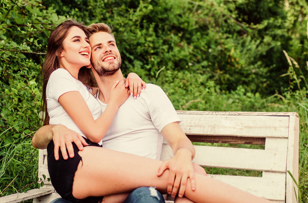 Cheerful couple. couple relax outdoor on bench. Secret place. man with woman in park. happy valentines day. summer camping in forest. family weekend. romantic date. couple in love. Happiness - Photo, image