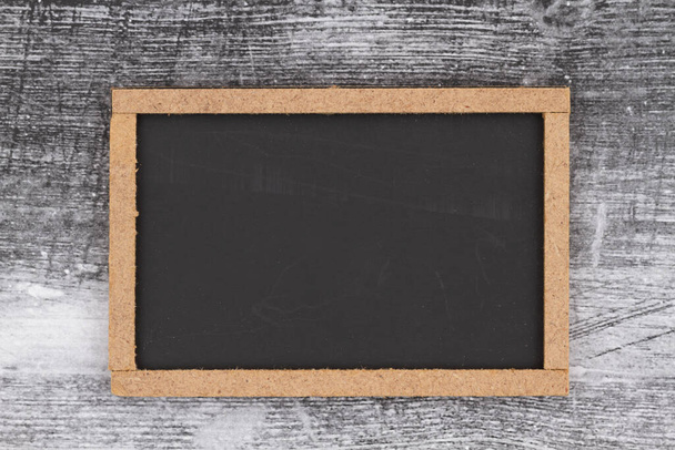 Blank grunge chalkboard sign with wood frame on distressed background - 写真・画像