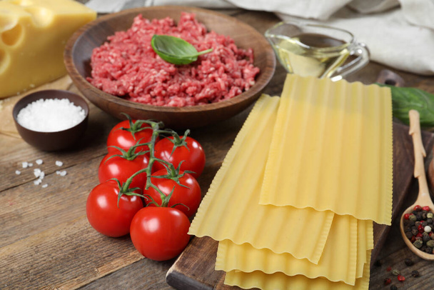 Fresh ingredients for lasagna on wooden table - Foto, imagen