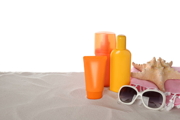 Composition with sun protection products on sand against white background. Space for text - Foto, Imagen