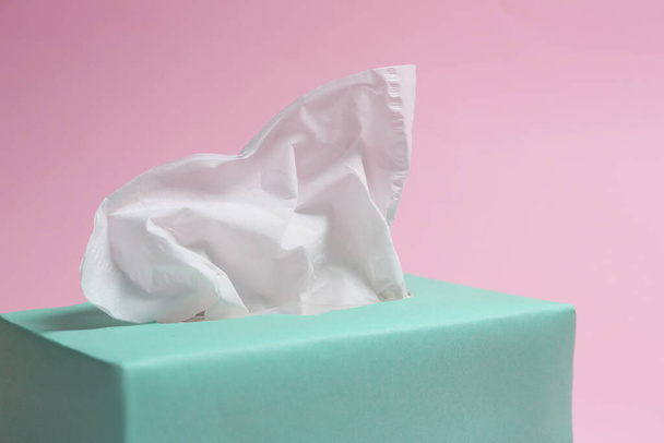 Box with paper tissues on pink background, closeup - 写真・画像
