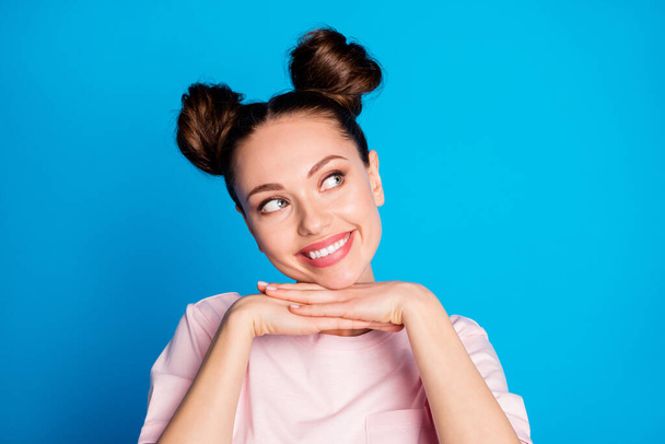 Closeup photo of attractive funny expression lady two pretty buns dreamy look side empty space arms under chin wear casual white pink t-shirt isolated bright blue color background - Fotoğraf, Görsel