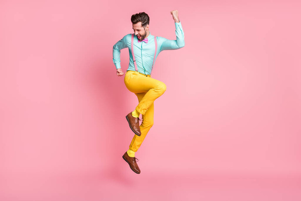 Full length body size view of his he nice well-dressed attractive classy cheerful cheery glad brunet guy gentleman jumping rejoicing having fun isolated over pink pastel color background - Fotografie, Obrázek