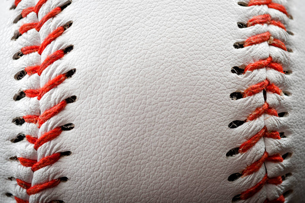 Macro image of a baseball with the closeup on the stitches with copy space - Photo, Image