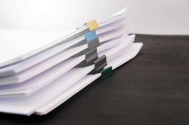 A pile of unfinished documents on an office desk, a desk of business paper. stack with documents on a black background. Close-up. Copy of space. - Fotografie, Obrázek