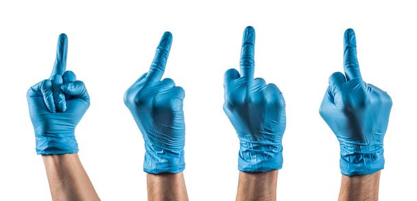 Algumas mãos com luva de látex azul mostrando o dedo médio
 - Foto, Imagem