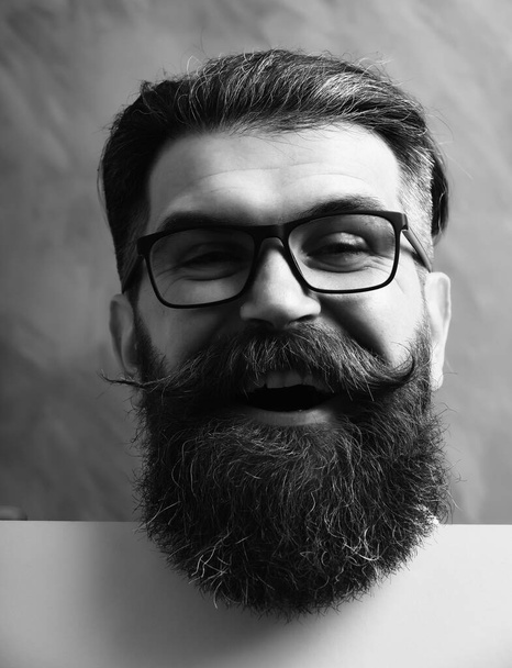 bearded man with happy face in glasses on orange background - 写真・画像