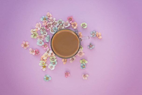 Cup of coffee on a pink background with flowers. Minimalist concept for your mockup and project. Layout, flat lay, copy space, top view. Selective focus. - Foto, Imagen