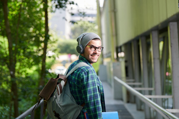 young student with glasses walks around college campus - Фото, изображение