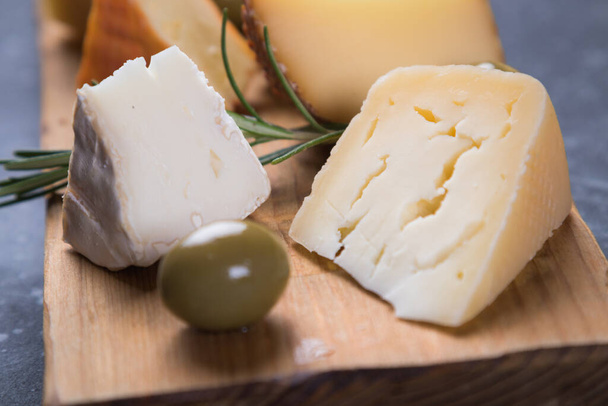 Cheese platter with blue, aged, yellow and white cheeses - Fotó, kép