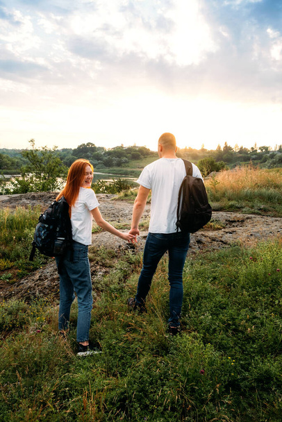 Local travel, Solo Explorers, Small Group tourist. Young couple going for hiking, walk in nature. Summer Outdoor Activities. Caucasian hiker couple enjoying themselves on summer vacation. - Foto, Imagem