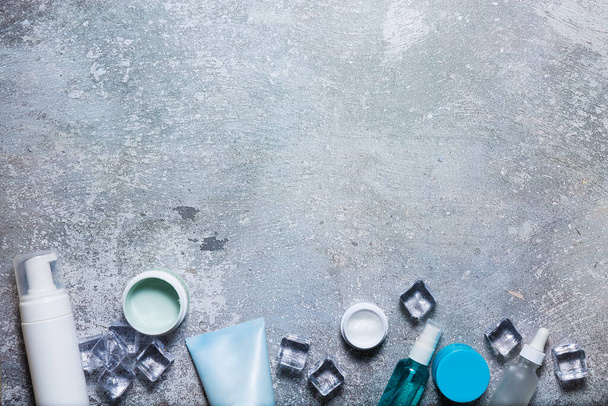 Cosmetics on a concrete background with ice cubes - Photo, Image