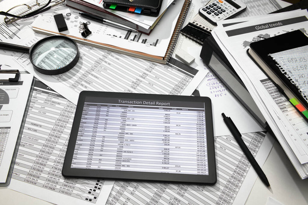 business office desk closeup - tablet computer met tabellen en grafieken op het scherm, financiële verslagen, analyse en boekhouding, set van documenten voor de boekhouding - Foto, afbeelding