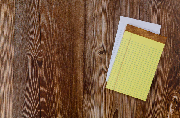 Top view of a open notebook with office notepad flat lay on a wood background - Photo, image