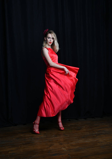young and beautiful girl tries on her first evening red dress - Фото, изображение